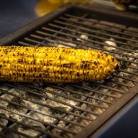 A street vendor roasts corn on a charcoal grill in Istanbul,